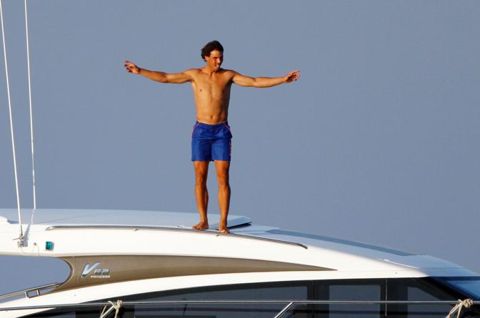 Il campione di tennis Rafael Nadal si concede un vacanza sotto il sole della sua Spagna. Eccolo, in un gesto simile a quello di Leonardo Di Caprio nella celebre scena del Titanic,  mentre si cimenta in tuffi dallo yacht (Olycom)